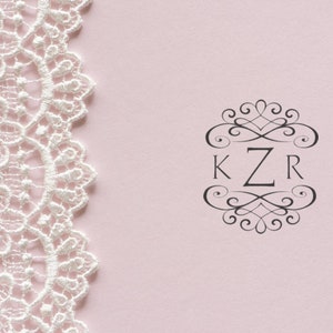 Elegant customizable self-inking rubber stamp design featuring intricate lace pattern and monogram KZR on a soft pink background, perfect for personalized stationery and crafting projects.