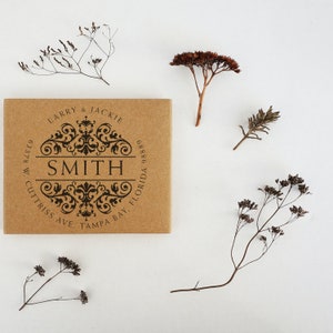 May include: A brown, rectangular return address stamp with a black ornate design and the text "LARRY & JACKIE SMITH 63378 W CUTTRISS AVE. TAMPA BAY, FLORIDA 98889".