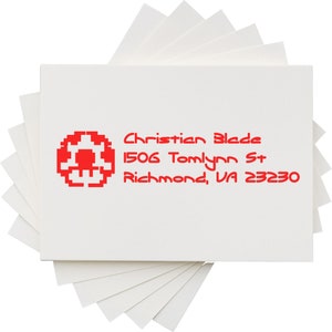 Unique rubber stamp design featuring a pixelated video game theme, perfect for creating a unique address stamp. Ideal for fans of video game merchandise, adding a personalized touch to envelopes and stationery.