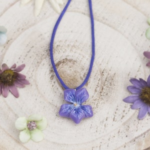 Necklace with violet flower pendant made of cold porcelain