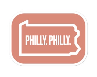May include: A peach-colored sticker with a white outline of the state of Pennsylvania. The text "PHILLY. PHILLY." is inside the outline.