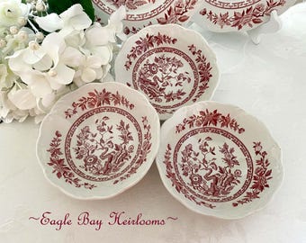 May include: Three white and maroon floral patterned bowls with scalloped edges. The bowls feature a detailed botanical design with a central motif and border. The bowls are part of a vintage tableware set.