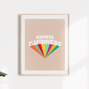 May include: A framed print with a peach background and the text "CHOOSE KINDNESS" in white with a rainbow-colored design behind the text.