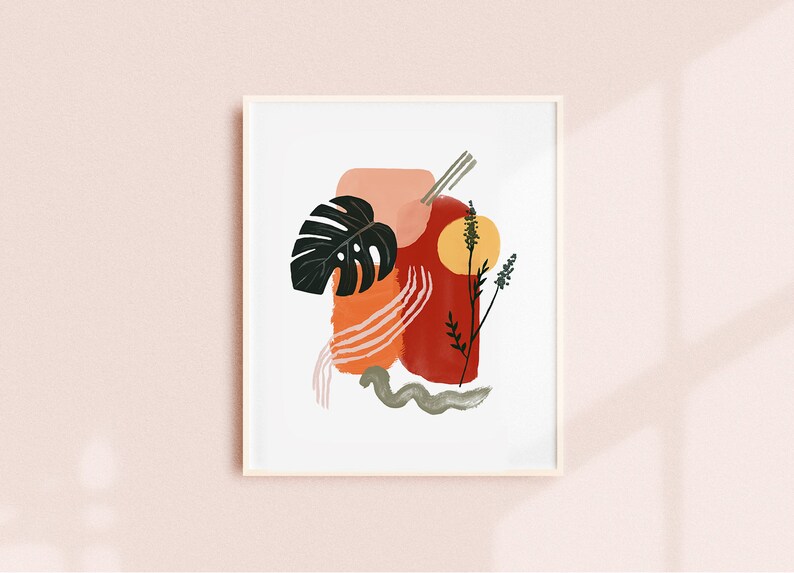 May include: Abstract art print featuring a red, orange, and pink abstract design with a green leaf and a yellow circle. The print is framed in a white frame.