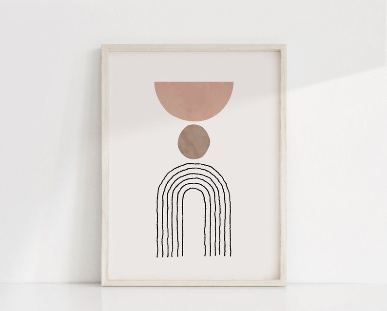 May include: A framed print with a minimalist abstract design featuring a pink and brown semi-circle and circle, and a black and white arch shape.