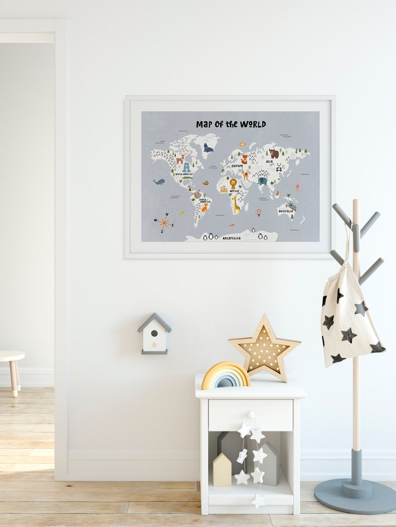 May include: A white framed world map with colorful illustrations of animals on each continent. The map is hanging on a white wall in a room with a white nightstand, a wooden star, and a rainbow toy.