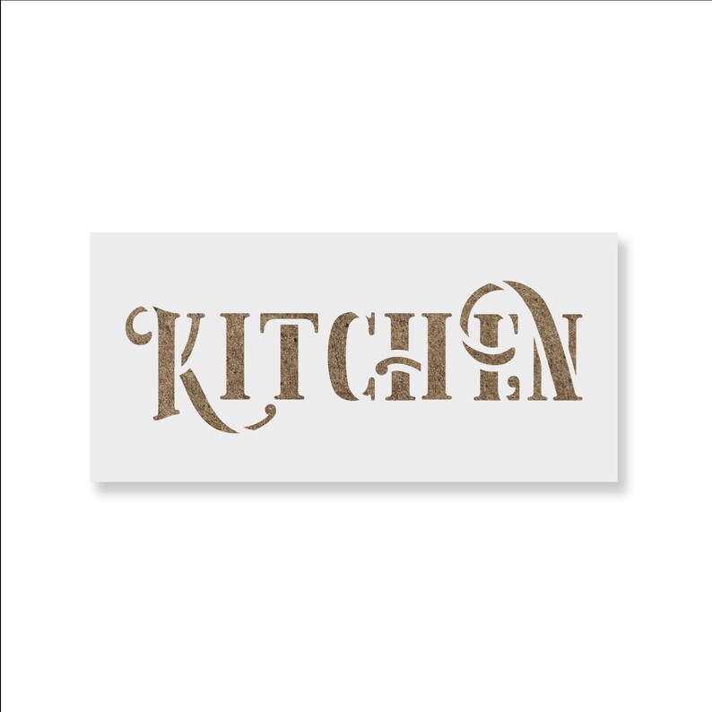 May include: A rectangular stencil with the word "KITCHEN" cut out in a decorative font. The letters are a textured, light brown color, and the stencil itself is white. The design is centered on the stencil.