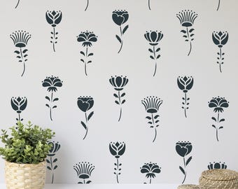 May include: A wall surface featuring a repeating pattern of dark gray stylized floral motifs. The design consists of various individual flower shapes with stems and leaves arranged in a vertical grid. The flowers have distinct petal structures.