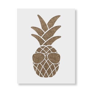 May include: A stencil featuring a brown pineapple wearing sunglasses. The pineapple has a diamond pattern on its body and a leafy crown. The stencil is on a white background.