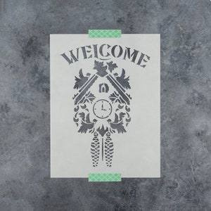 May include: White stencil with the word "WELCOME" above a black silhouette of a cuckoo clock with a clock face and a bird on top.