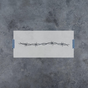 May include: A rectangular stencil featuring a horizontal barbed wire design. The stencil is light gray with a dark gray barbed wire pattern cut out in the center. Small blue and white patterned tape strips are visible on the left and right edges.