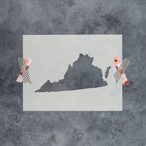 May include: A white stencil of the state of Virginia, with a gray outline of the state. The stencil is on a gray background.