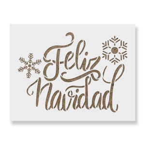May include: A rectangular stencil featuring the brown text Feliz Navidad in a cursive script font. The design includes a small snowflake icon to the left of the word Feliz and a larger, more detailed snowflake icon to the right of the text.
