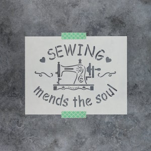 May include: A white stencil with the text "Sewing mends the soul" and a vintage sewing machine graphic.