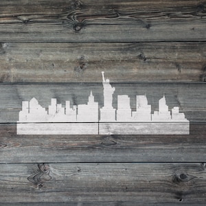 May include: A white silhouette of the New York City skyline with the Statue of Liberty on a weathered wood background.