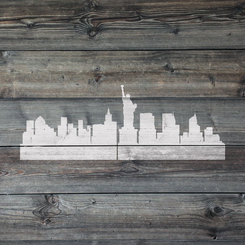 May include: A white silhouette of the New York City skyline with the Statue of Liberty on a weathered wood background.