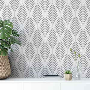 May include: A wall surface featuring a repeating pattern of gray, stylized palm leaf shapes on a white background. The design consists of vertical rows of symmetrical, pointed leaf segments arranged in a consistent, geometric, and rhythmic layout.