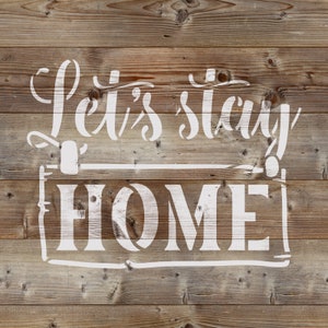 May include: White painted wood sign with the text "Let's stay home" in a decorative font.