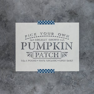 May include: White stencil with the text "Pick Your Own Locally Grown Pumpkin Patch 25¢ a pound 100% Organic Open Daily".