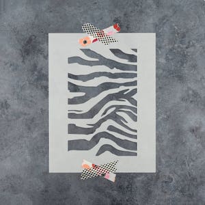 May include: A white stencil with a black zebra stripe pattern. The stencil is rectangular and has a smooth surface.