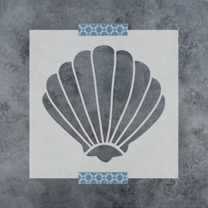 May include: A stencil of a gray seashell on a white background. The seashell is a simple design with a rounded shape and a series of lines radiating from the center.