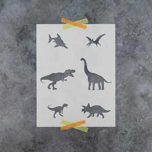 May include: A stencil sheet with six different dinosaur and sea creature silhouettes. The silhouettes are of a T-Rex, a Brachiosaurus, a Triceratops, a Pterodactyl, a Plesiosaur, and a shark.