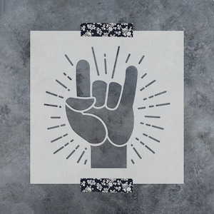 May include: A black and white stencil of a hand making the rock and roll hand gesture with a sunburst behind it.