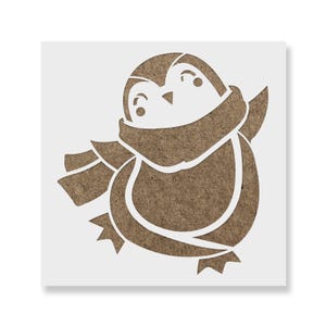 May include: A square stencil featuring a cutout design of a penguin wearing a scarf. The penguin is depicted with a rounded body, small flippers, and webbed feet. The design is rendered in a brown, textured material against a white background.