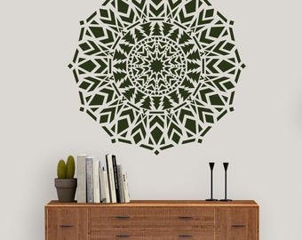 May include: A dark green wall decal featuring a complex, symmetrical mandala pattern with geometric shapes, small circles, and stylized tree motifs arranged in concentric rings, creating a large, circular, decorative graphic design.