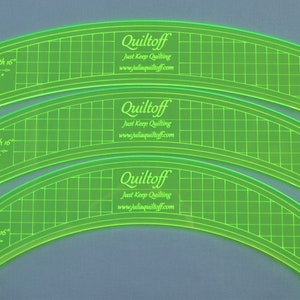 May include: Three green acrylic quilting rulers with gridded markings. The rulers are curved and labeled "Quiltoff" with the website address "www.juliaquiltoff.com". Each ruler has a different radius: 22 inches, 16 inches, and 8 inches. The rulers are 16 inches long.