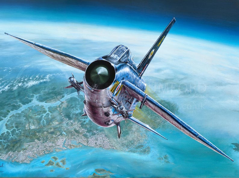 May include: A silver fighter jet flies over a blue and green landscape. The jet has a large, round engine and a pointed nose. The jet is flying low to the ground, and the landscape is visible below.