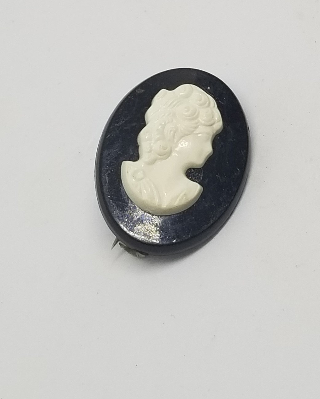 Vintage plastic black and white cameo brooch