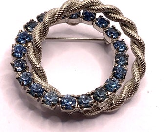 Vintage double circle silver tone and blue rhinestone brooch