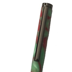 Slim Line Pen hand turned out of Christmas Acrylic with black hardware