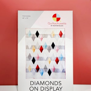 May include: A quilting pattern titled "Diamonds on Display" by Heather Black. The pattern is for an intermediate level quilter and measures 60 inches by 78 inches. The pattern features a colourful quilt with a diamond design.