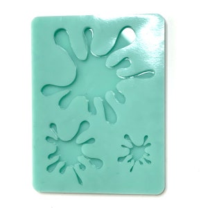 Puede incluir: Un molde de silicona verde claro con tres formas de salpicaduras de pintura. El molde está diseñado para hacer manualidades de resina.