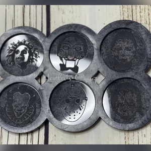 May include: A set of six black coasters with a circular design. Each coaster features a different horror movie character, including Jason Voorhees, Freddy Krueger, Michael Myers, and more.
