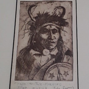 May include: A sepia-toned etching of a Native American man wearing a feathered headdress. The man is holding a shield with two stars. The etching is titled "Chase-In-The-Morning" and signed "Sioux, Ella Tanner".