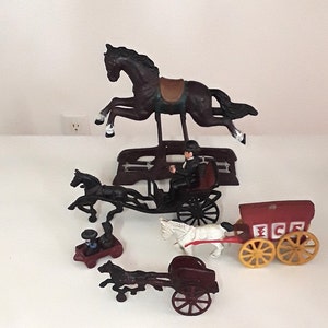 5 Vintage Cast Iron Toys, Including Rocking Horse, Horses Pulling Gentleman in Carriage, Ice Wagon, & Cart, and Wilton Amish People in Wagon