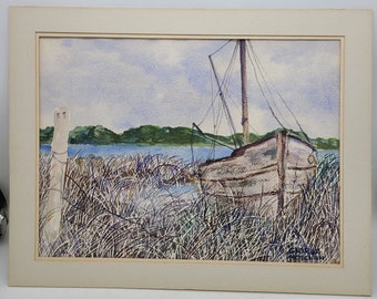 May include: A watercolor painting of a wooden boat partially submerged in a grassy marsh. The boat has a mast and sail, and the water is a light blue color. The sky is a pale blue with white clouds. The painting is framed in a white mat.