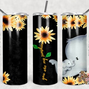 May include: A black and yellow stainless steel tumbler with a sunflower design and the text "You are my sunshine". The tumbler is shown with a straw.
