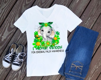 May include: White t-shirt with a green, yellow, and gray elephant graphic. The elephant is wearing a green bow and surrounded by green shamrocks. The text "I Wear Green for Cerebral Palsy Awareness" is printed below the elephant.