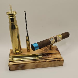 The all-in-one "Cigar Station" includes a 20mm Bullet oil Lamp, 50 cal BMG cigar Stand/Punch, 20mm Bullet Ashtray, 30-06 Draw Enhancer tool