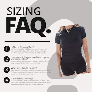 May include: A black short-sleeved t-shirt worn with black shorts. The image includes text titled SIZING FAQ. with four numbered points explaining the fit of the Gildan 5000B youth tee, noting it is 100% cotton and often worn as a fitted baby tee.