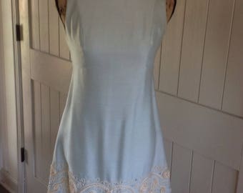 Vintage Baby Blue Silk 60's Dress with a border of robe and rhinestones design .