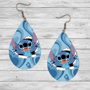 May include: A pair of blue teardrop-shaped earrings featuring a cartoon character of Stitch from Lilo & Stitch peeking out of a hole in the earring. The earrings have a swirling blue and white pattern.