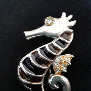 Vintage Brown Enamel Seahorse with Rhinestones in a Gold Tone Pin, Brooch.  The length of the pin is 1.5&quot; long.