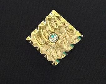 Palo de tono dorado vintage de mediados de siglo, pasador de solapa con una pequeña piedra en el centro