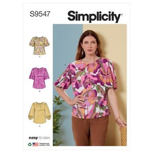 May include: Simplicity sewing pattern S9547 for a women's top with a round neckline and short sleeves. The pattern includes three different styles: a yellow floral top, a pink floral top, and a solid yellow top. The model is wearing a pink and purple floral top with brown pants.