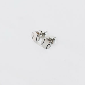May include: A pair of silver baseball stud earrings. Each earring features a small, round, silver baseball with black stitching.